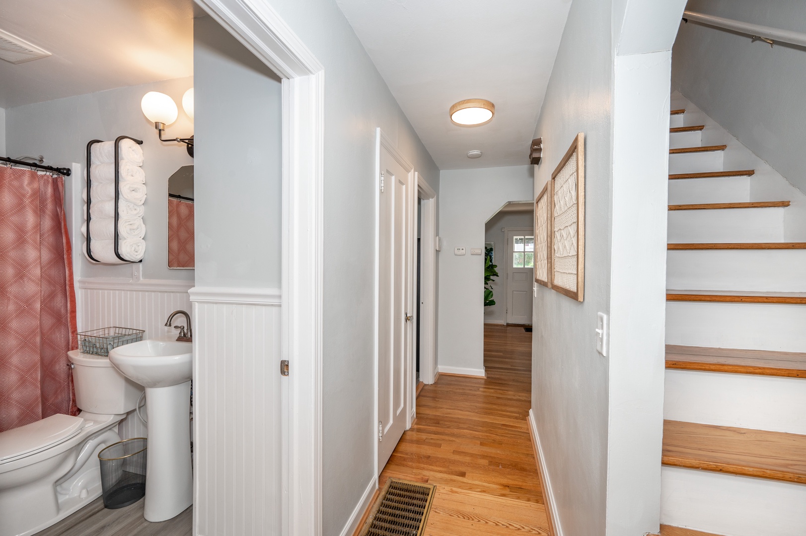 A central hallway connects the Living Spaces, Stairway, and 1st Floor Bathroom