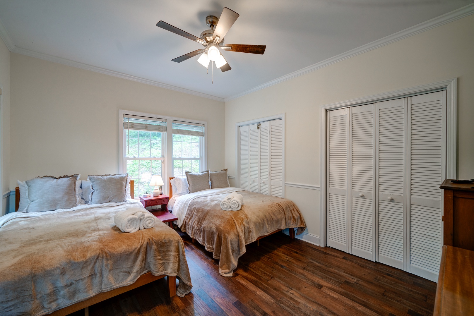 A pair of plush full-sized beds & a Smart TV awaits in this bedroom retreat