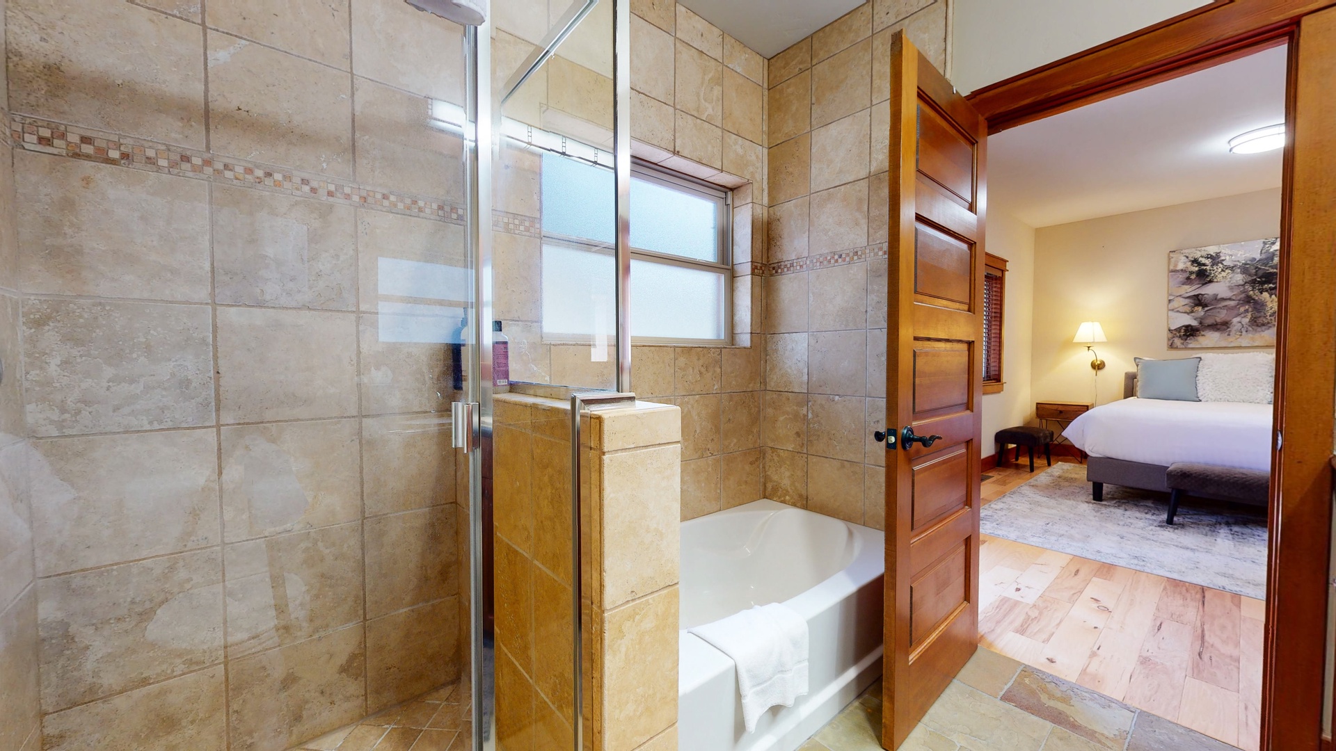 En suite bathroom with soaking tub, standing shower and dual sinks