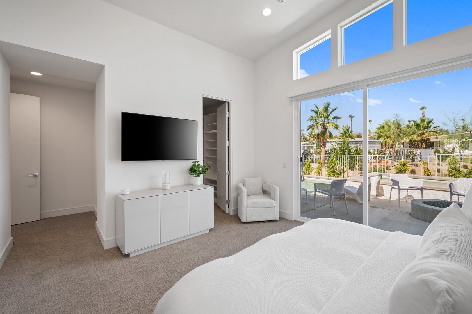 Bedroom 1 with King bed, TV, patio access, and private en-suite