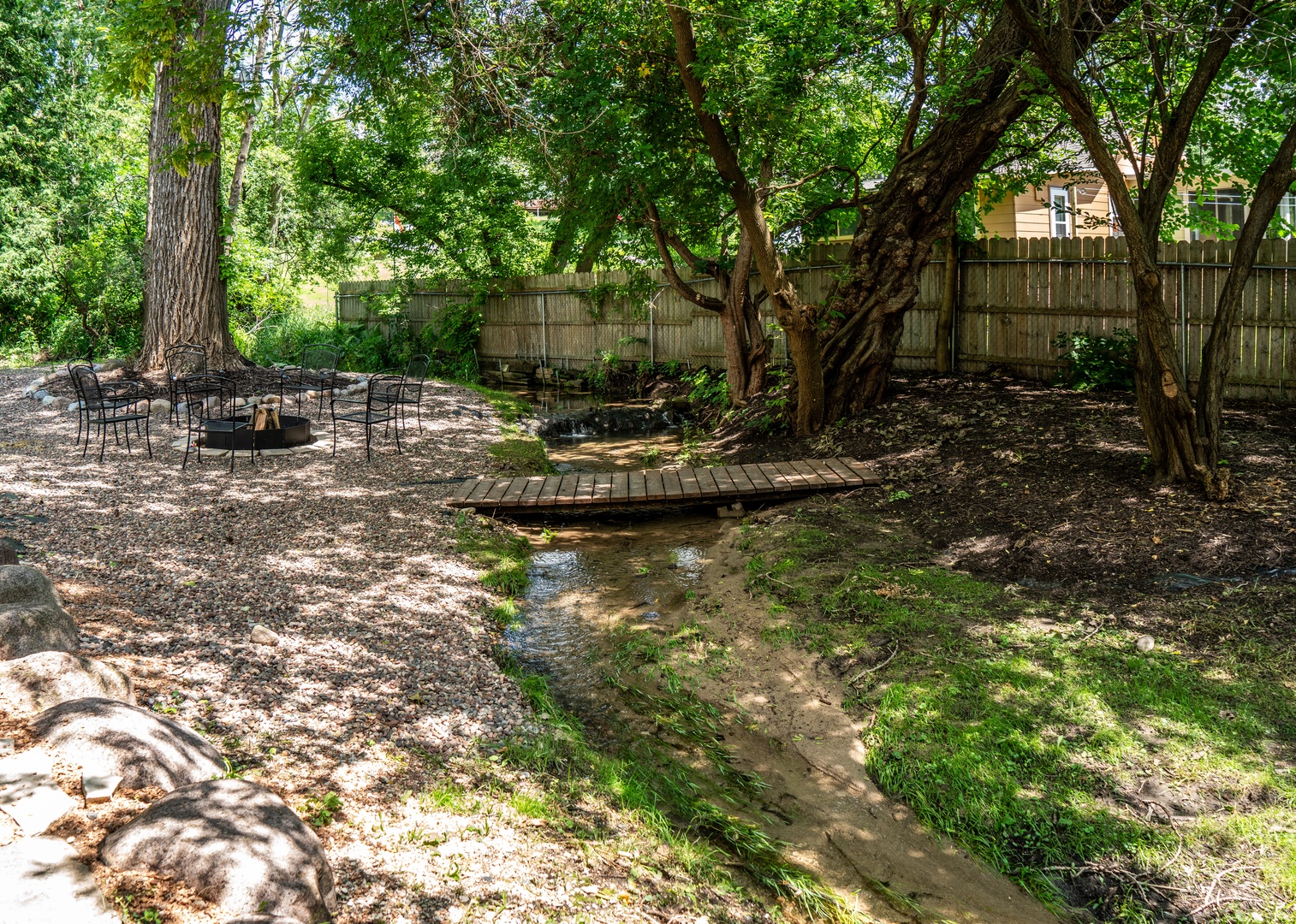 Unwind in the secluded backyard, serenaded by the soothing sounds of the stream