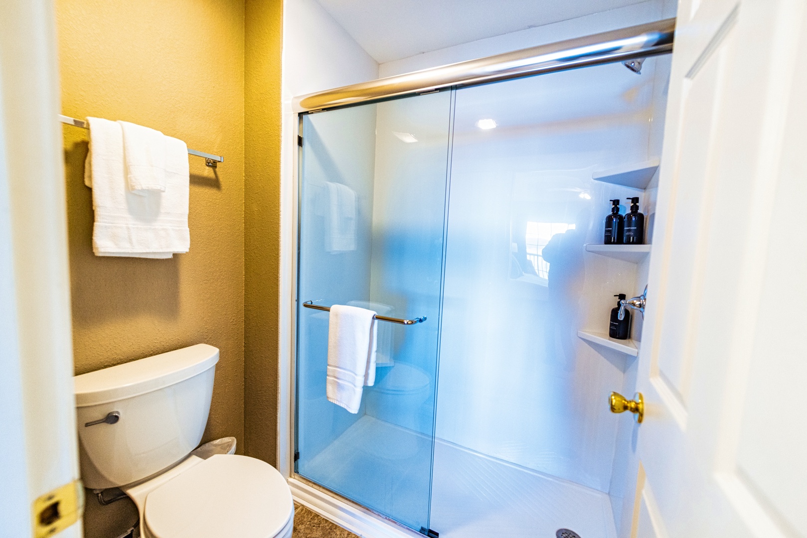 The king ensuite includes a single vanity, glass shower, & walk-in closet