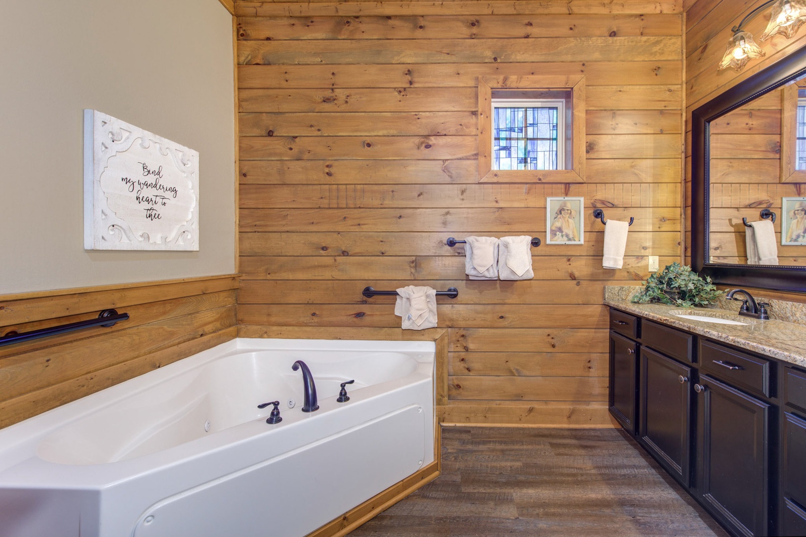 This ensuite offers a large vanity, walk-in shower, & luxurious soaking tub