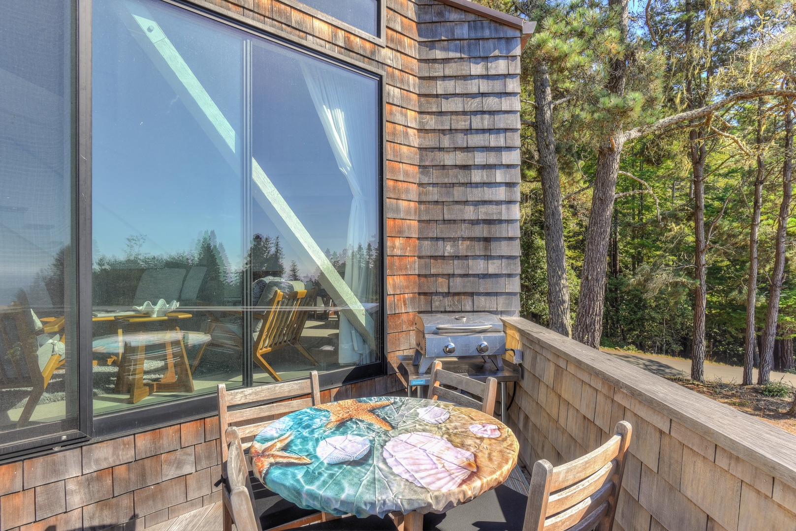 Back deck with outdoor seating, BBQ, and ocean view