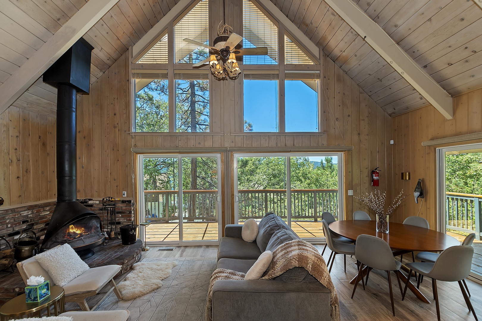 Bright living room with queen sofa sleeper, fireplace, and deck access