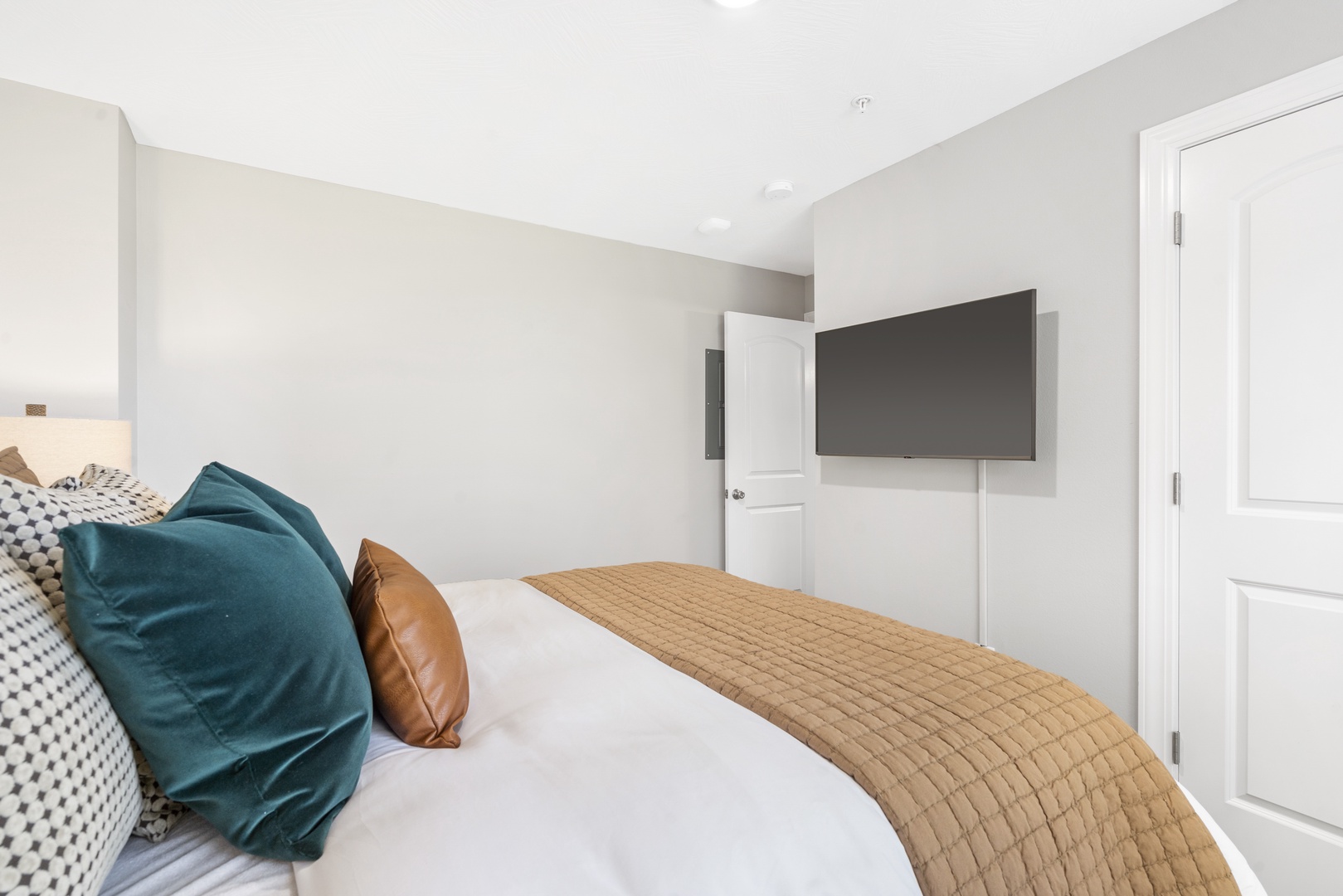 Relax in the final tranquil bedroom, complete with queen bed & smart TV