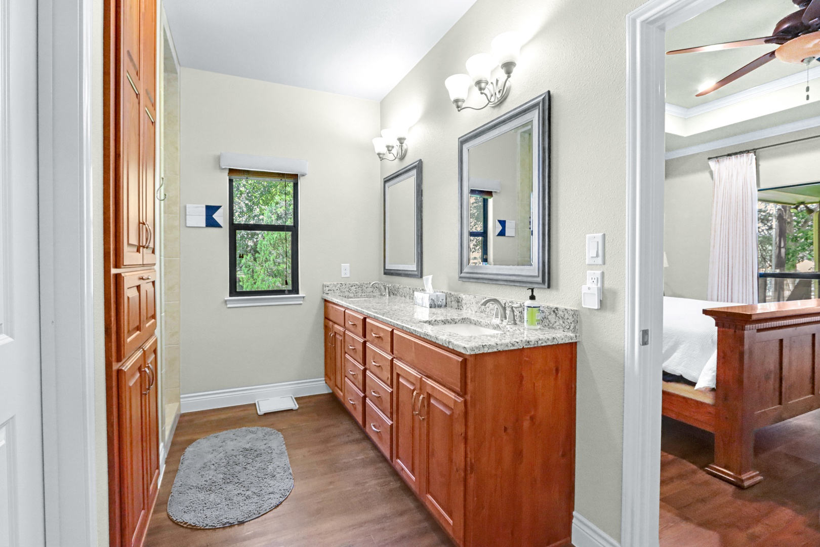 A double vanity & walk-in tiled shower await in this ensuite bath