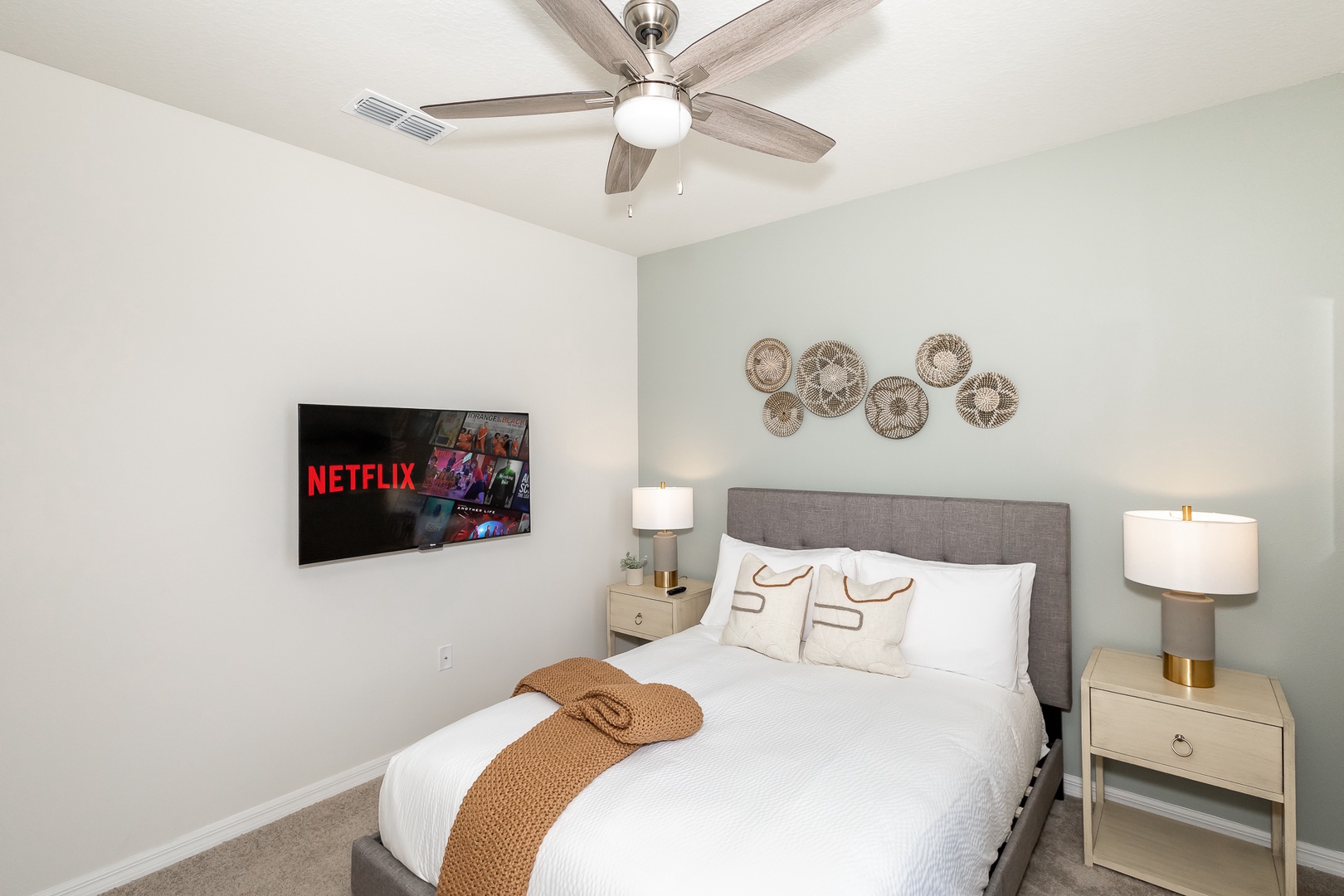 Bedroom 1 on the 1st floor offers a queen bed, Smart TV, & ceiling fan