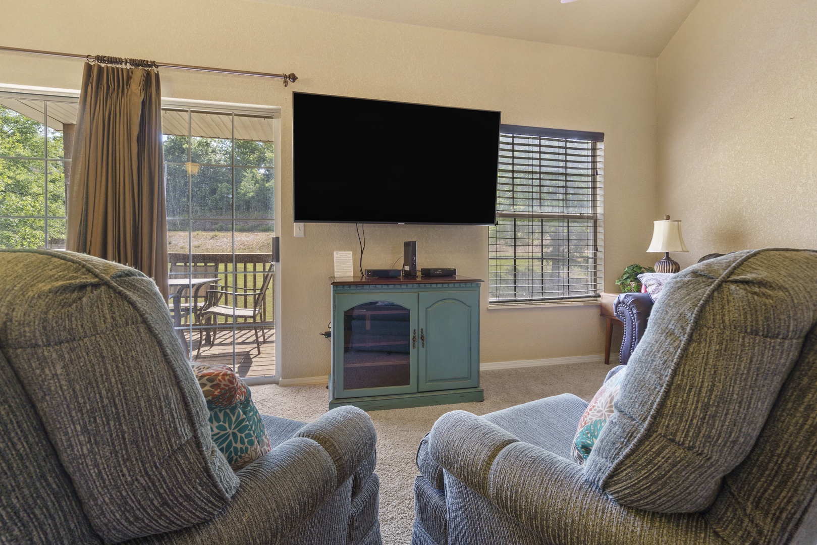 Living room features SmartTV and patio access