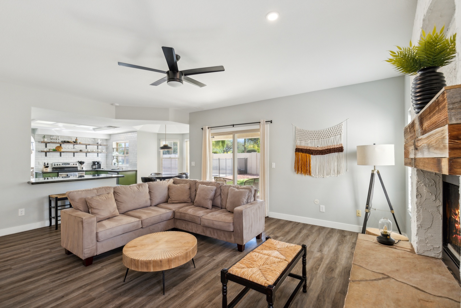 Living space off of the back yard with sectional sofa, fireplace, and Smart TV