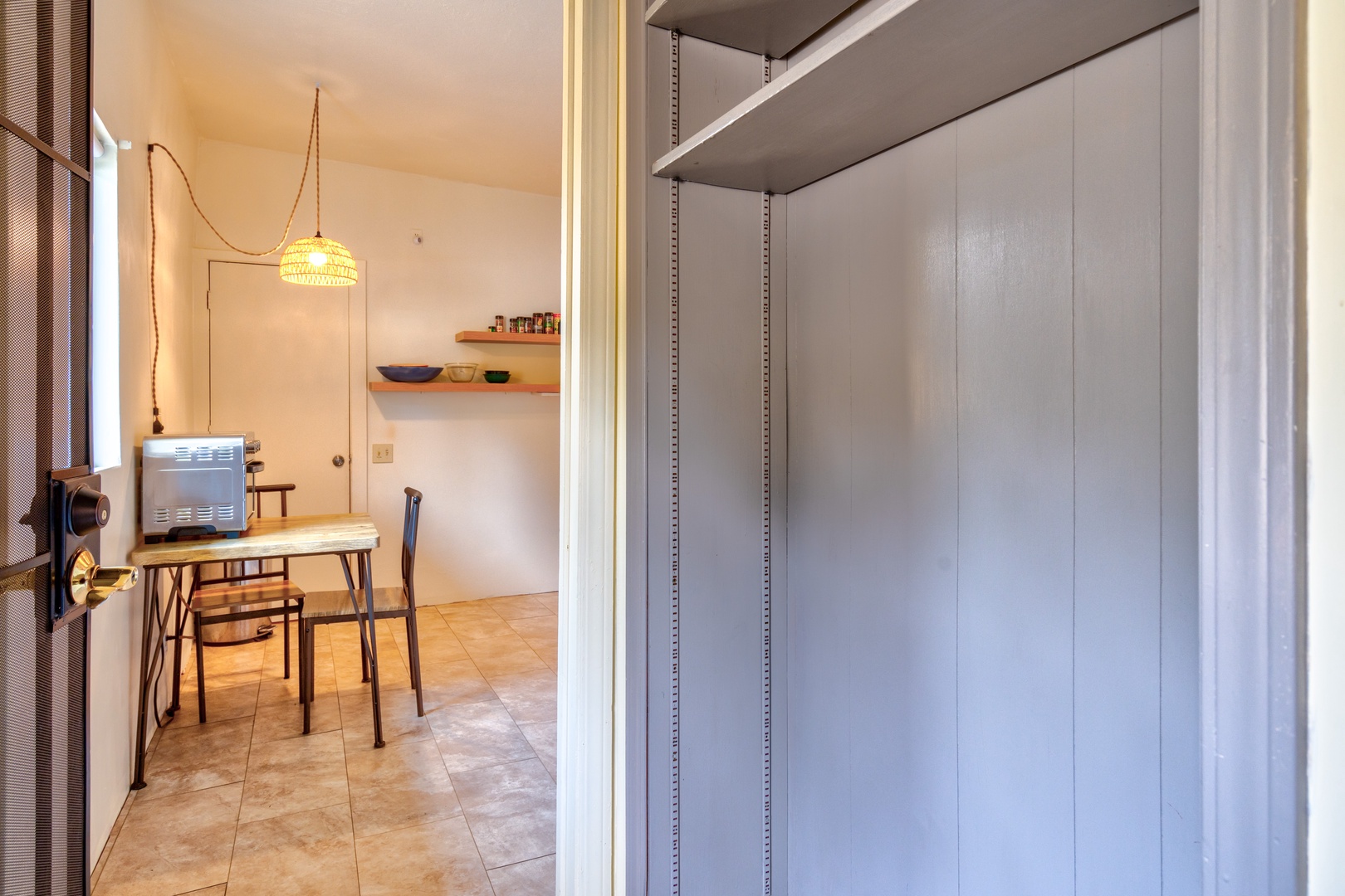 The open storage space off the kitchen is ideal for storing bags