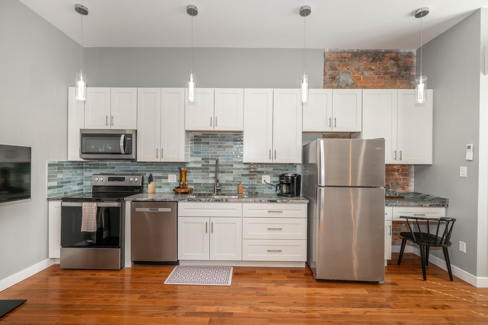 The sophisticated kitchen offers ample space & every home comfort