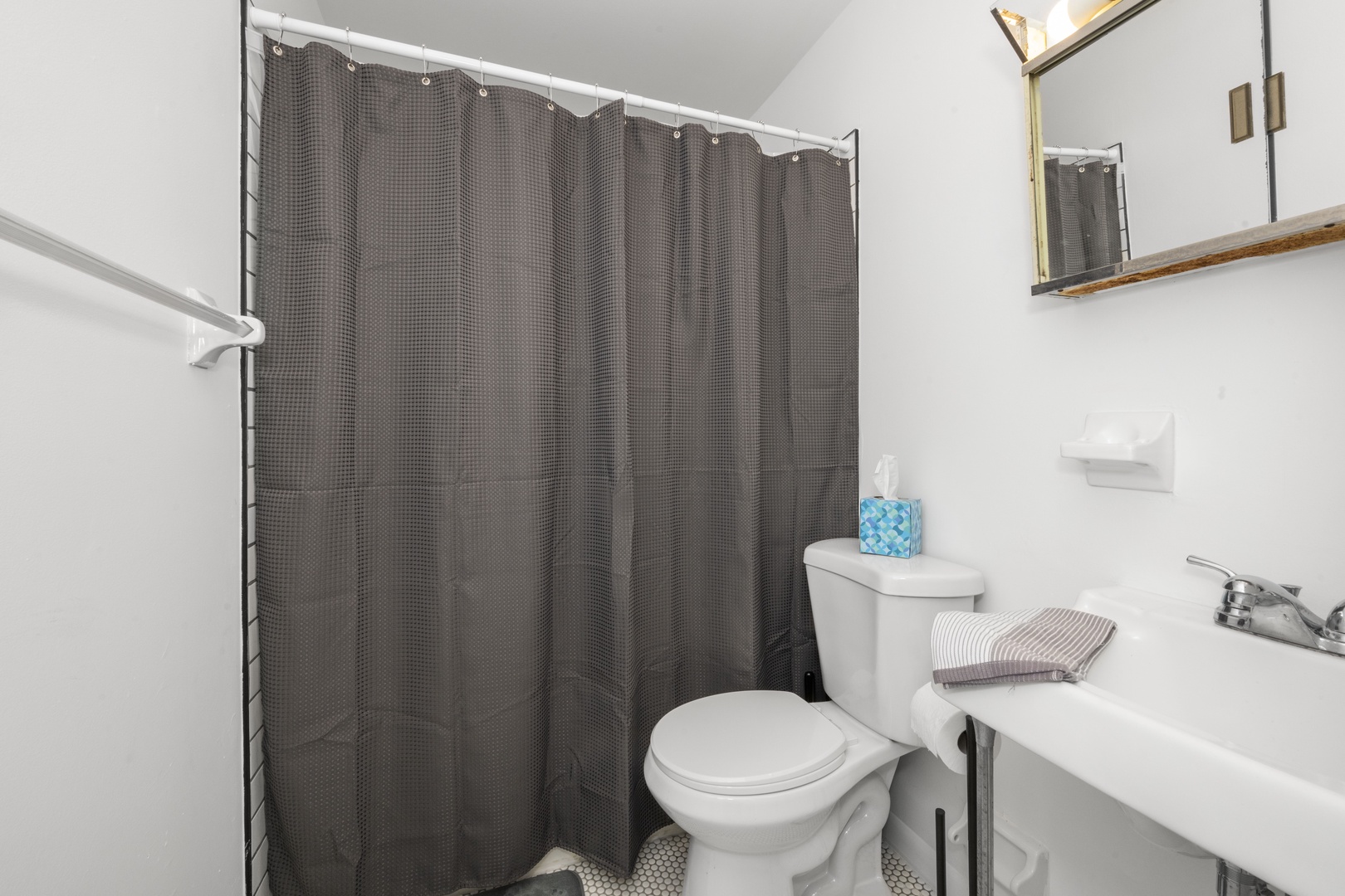Suite 4: The sophisticated full bath features a single vanity and shower/tub combo