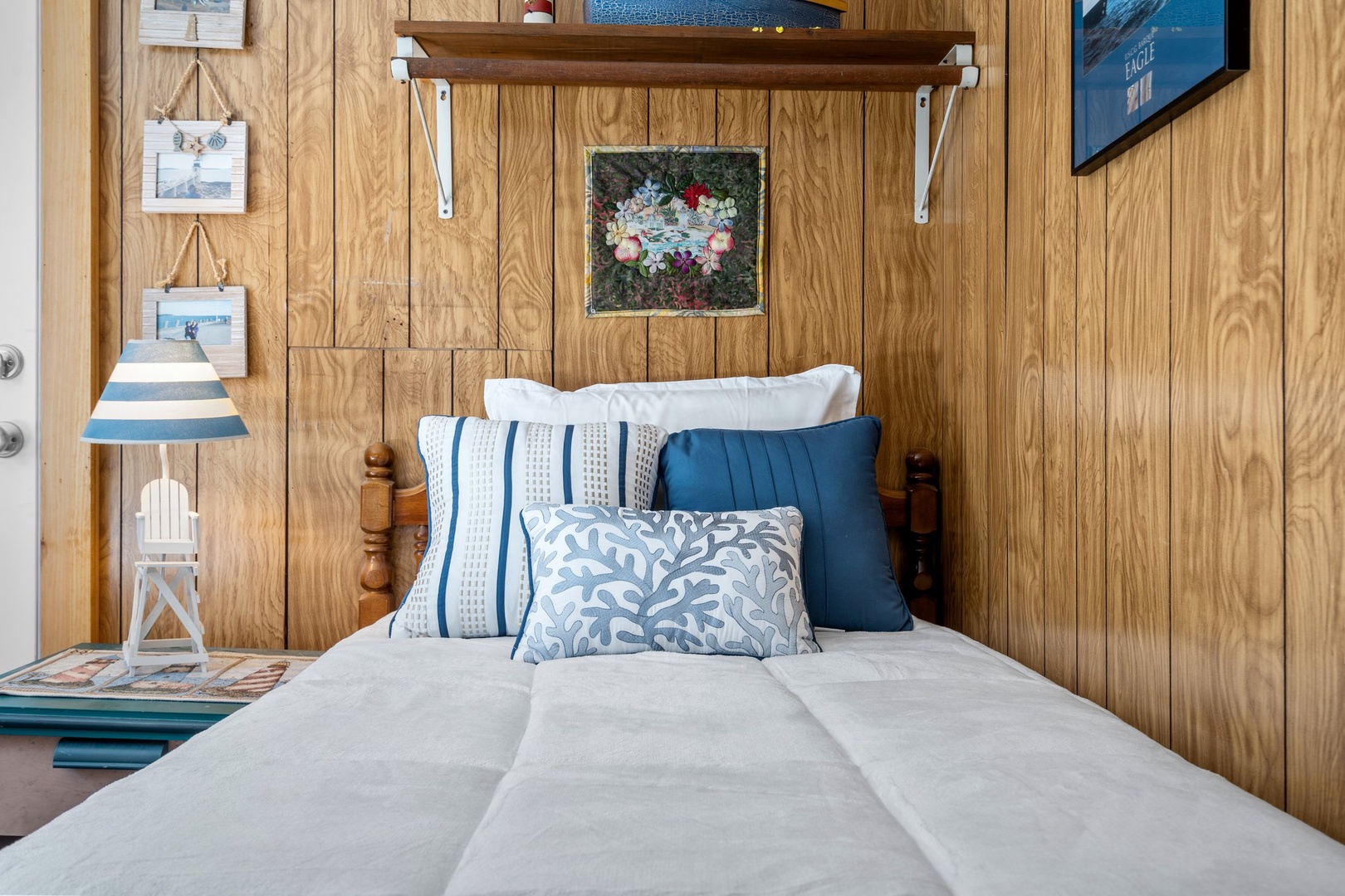 Bedroom 3 with queen bed, twin bed, and partial ocean view