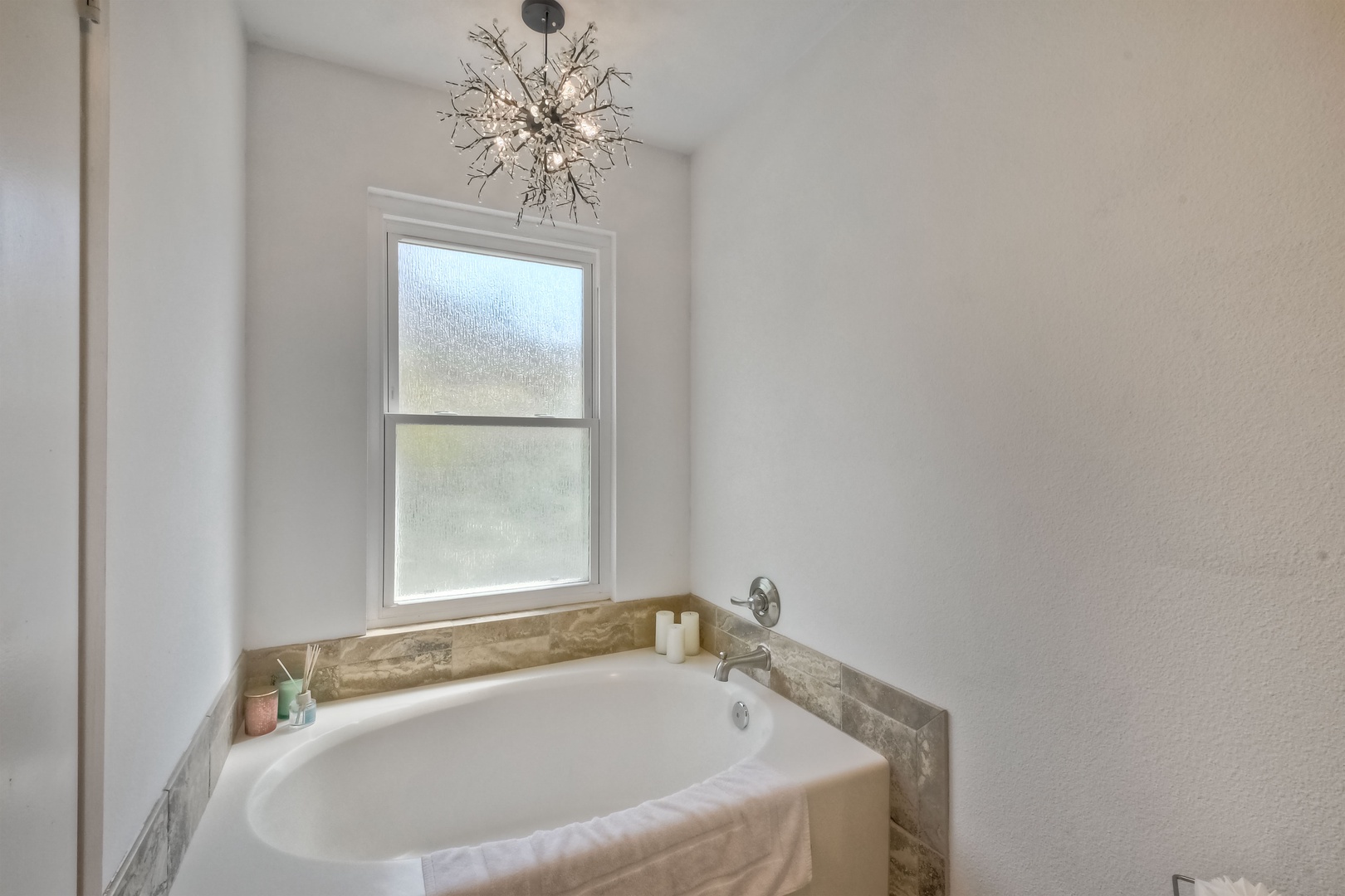 Ensuite bathroom with dual sinks, soaking tub, and stand-up shower