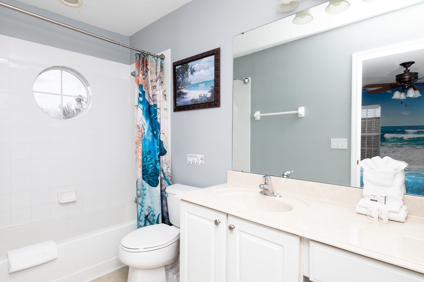 This ensuite bath features a single vanity shower/tub combo