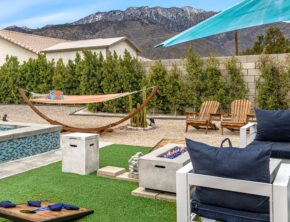 Outdoor seating around a fire pit by the pool