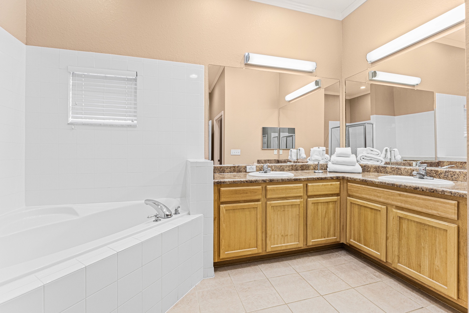 The king ensuite features a double vanity, shower, & luxe soaking tub