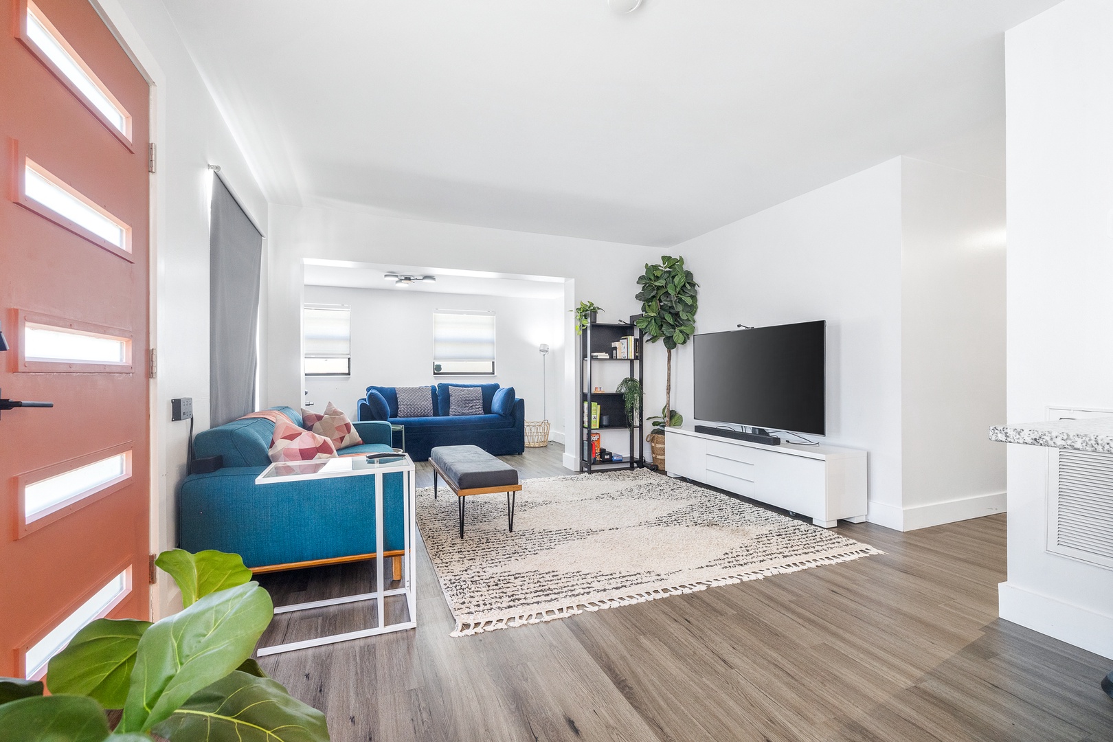 Bright living space with queen sofa sleeper, and Smart TV