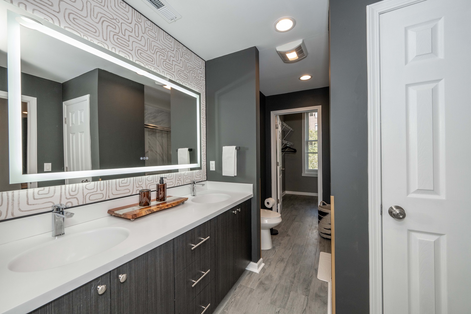 Wash up in the ensuite bath, featuring a double vanity & glass shower