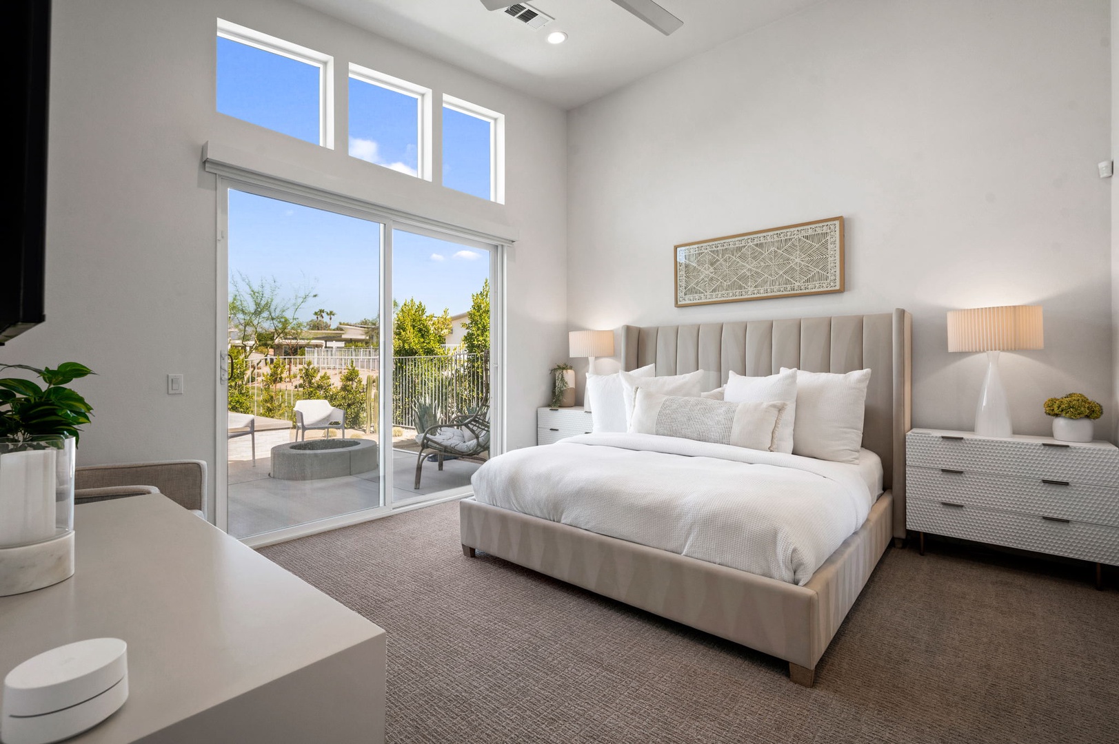 Bedroom 1 with King bed, TV, patio access, and private en-suite