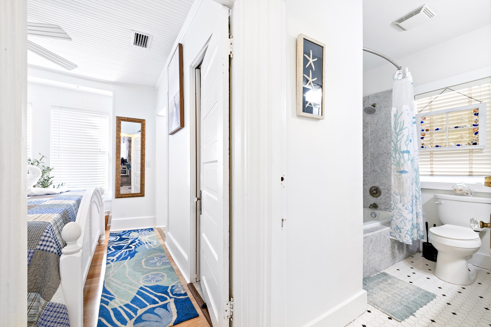 A spacious king bedroom & the home’s coastal full bath await on the 1st floor