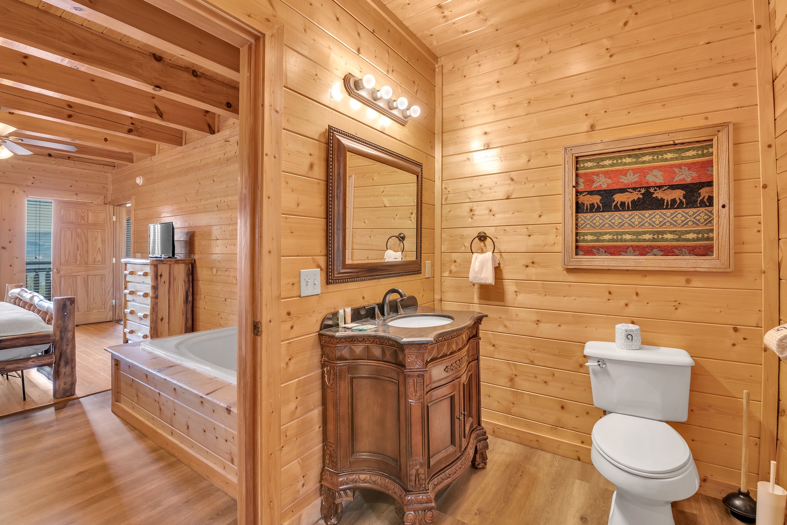 This full en suite bathroom includes a single vanity & walk-in shower
