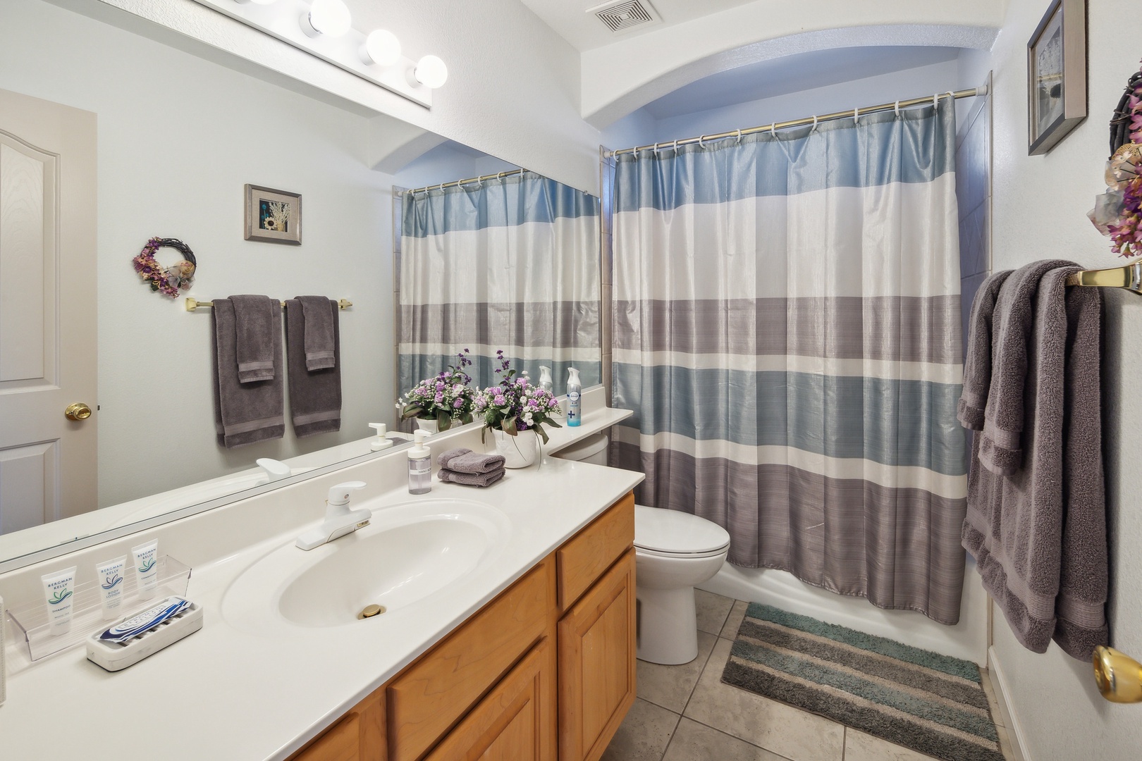 The hall bath features a large single vanity & shower/tub combo