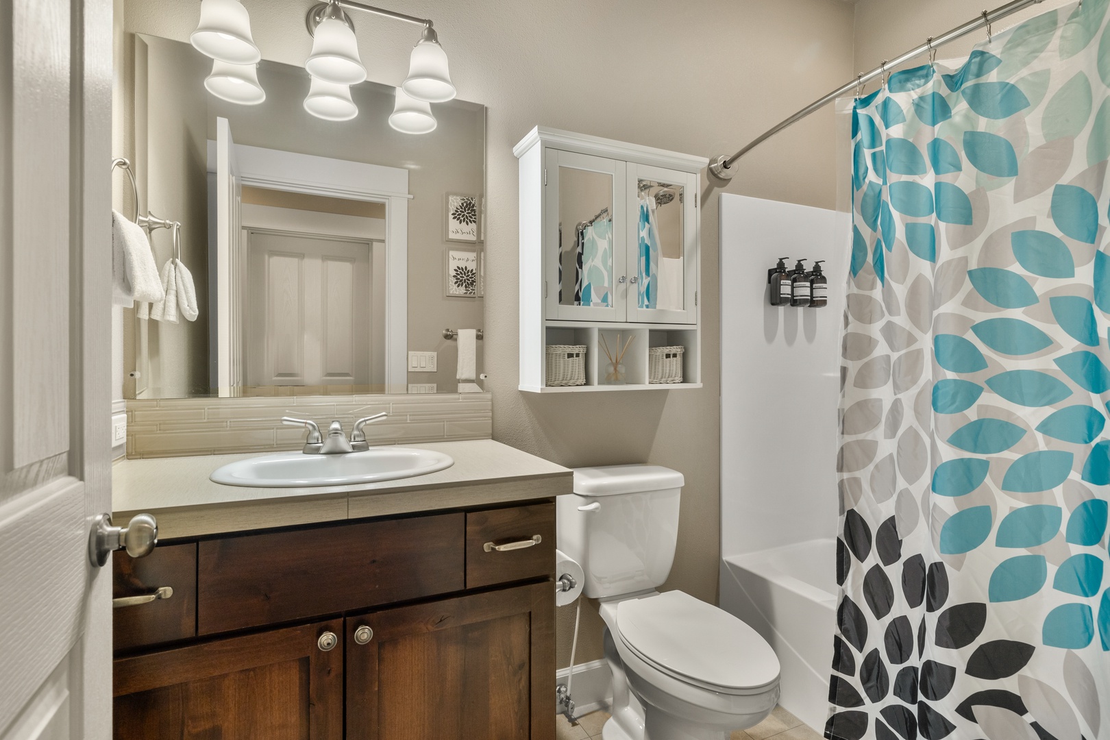 The hall bathroom offers a single vanity & shower/tub combo