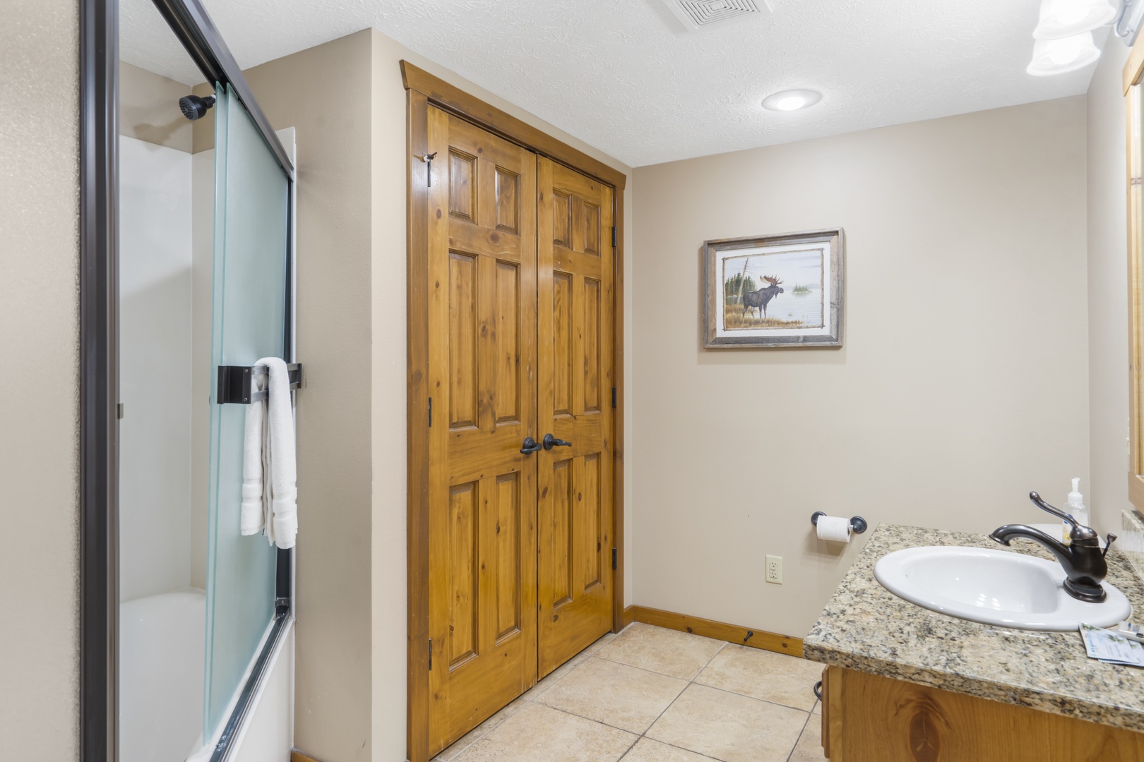 This 2nd-level ensuite includes a single vanity & large shower/tub combo
