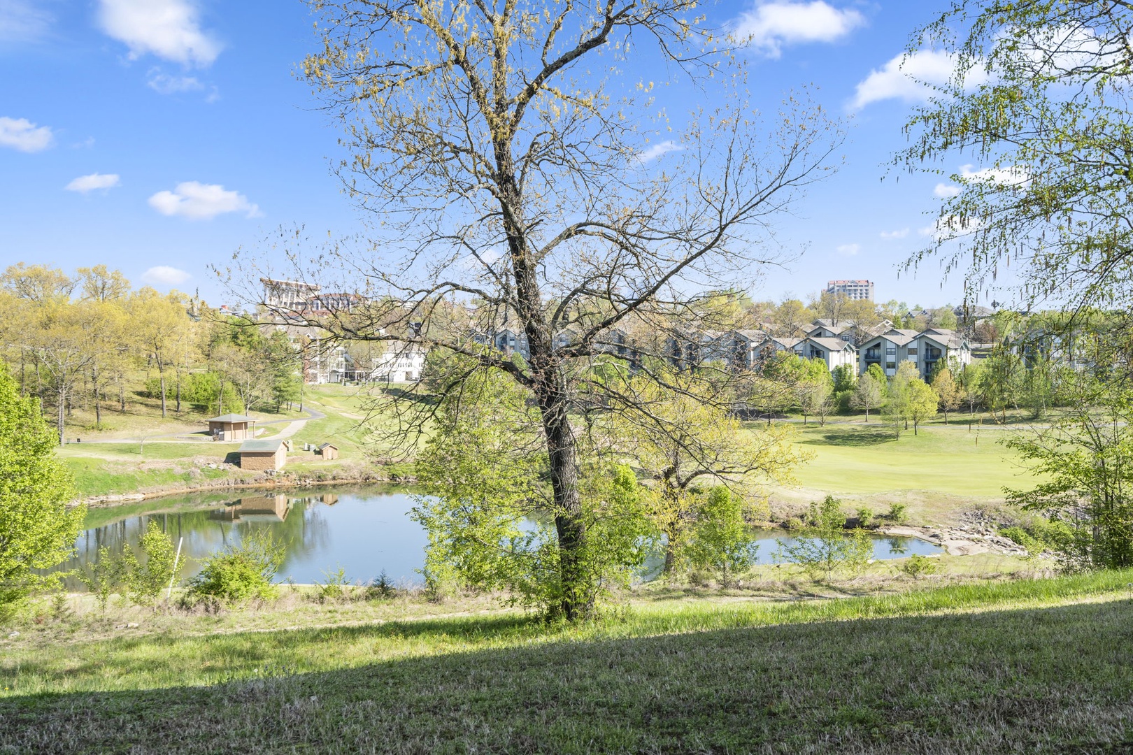 Enjoy tranquil views of rolling hills and a quaint pond from the covered patio
