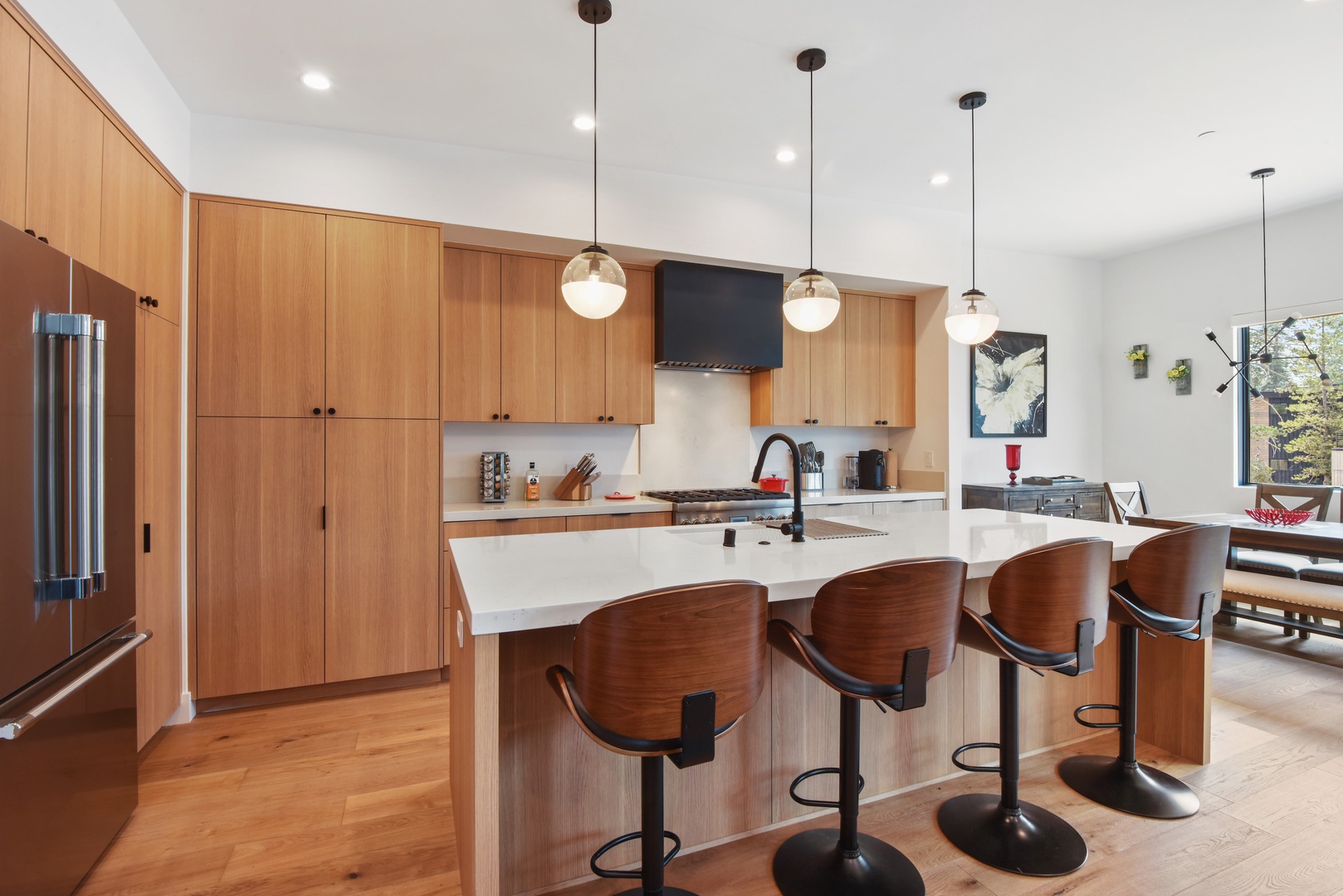 Modern kitchen with Nespresso, toaster, rice cooker, kettle, blender, wine fridge, and more