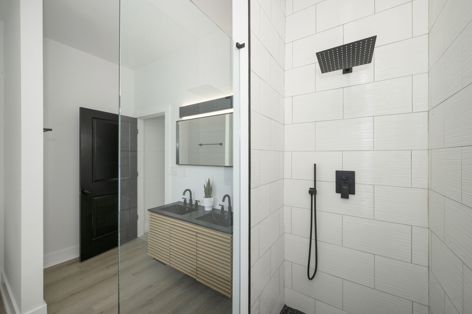 The king ensuite offers a sleek double vanity & luxurious glass shower