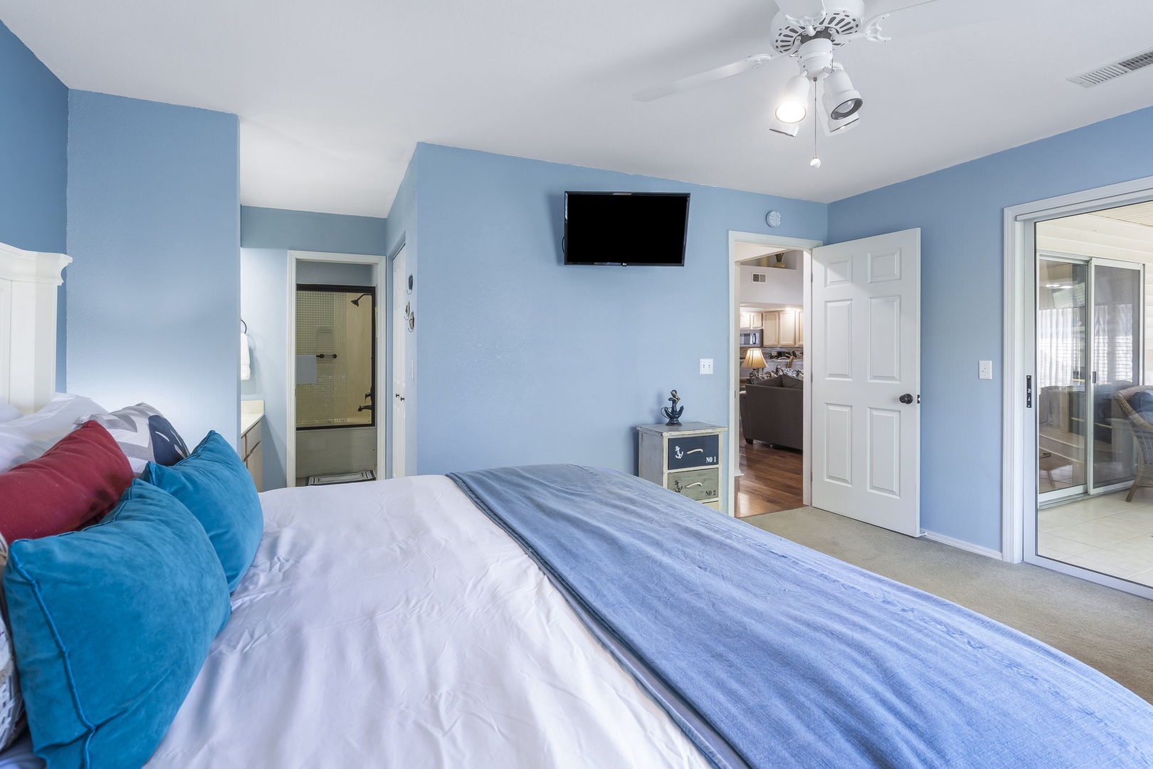 Bedroom 1 with King bed, en-suite, and patio access