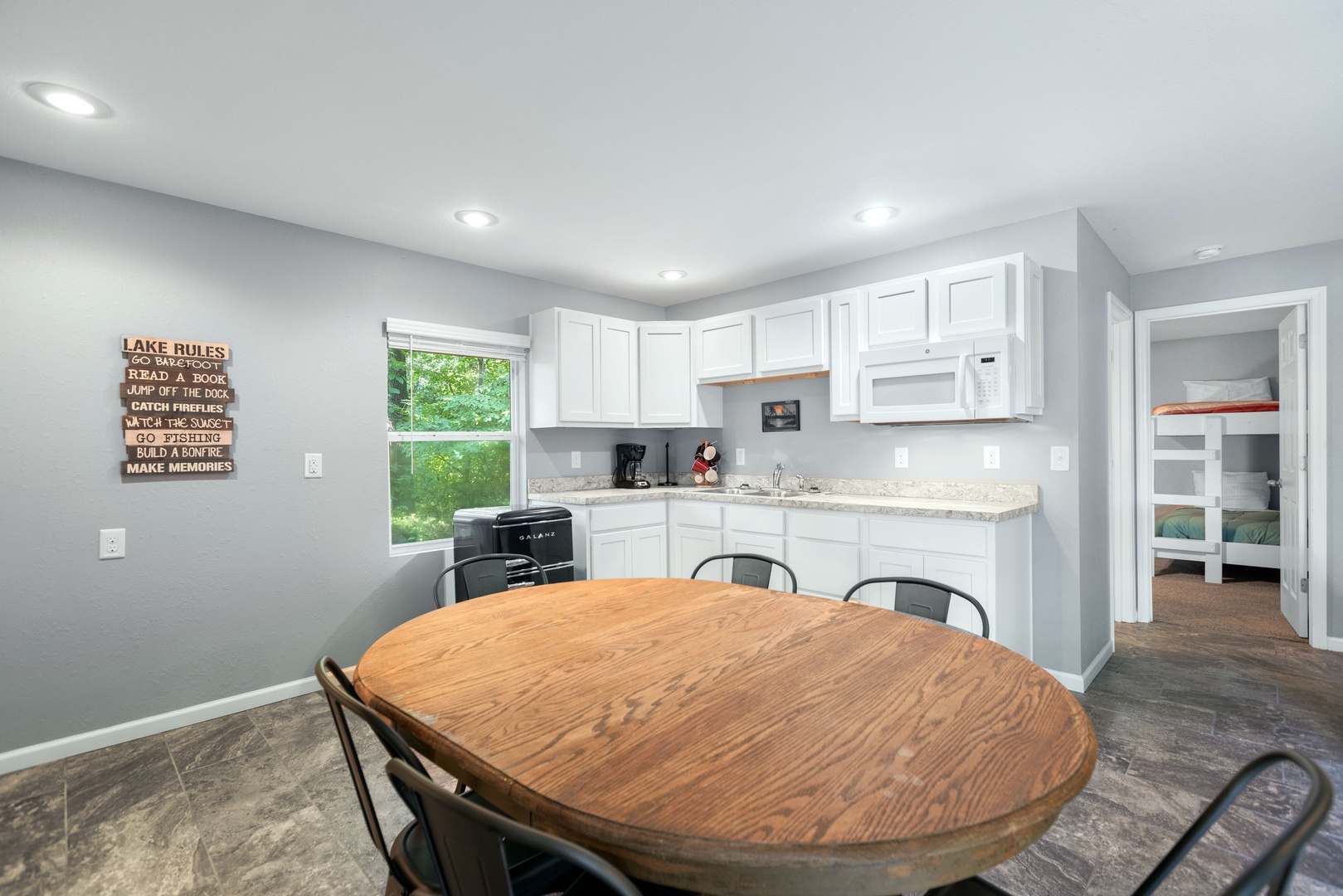 Enjoy the guest house kitchenette with seating for 6, featuring a mini fridge, microwave, and coffee maker