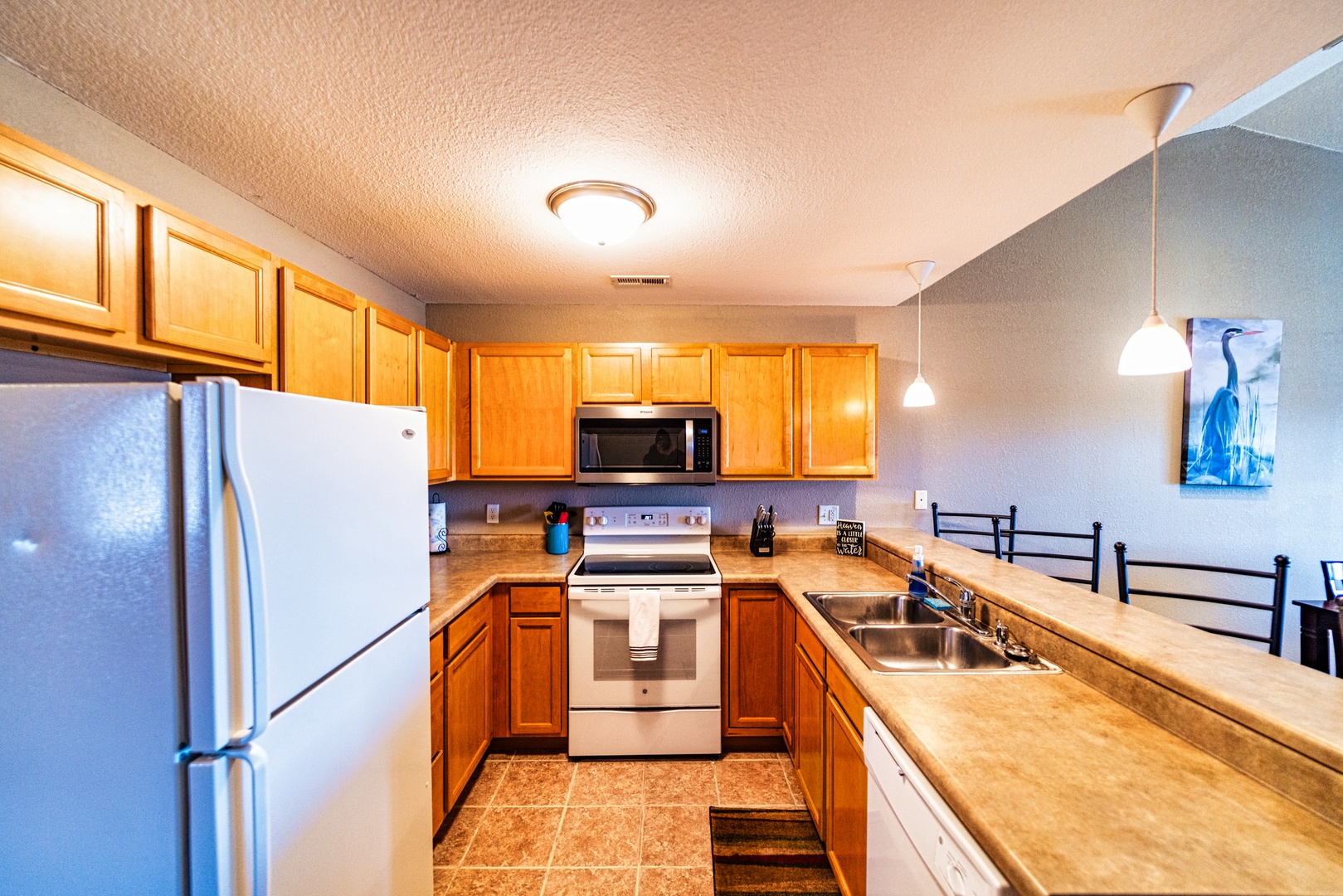 This quaint kitchen offers ample space & all the comforts of home