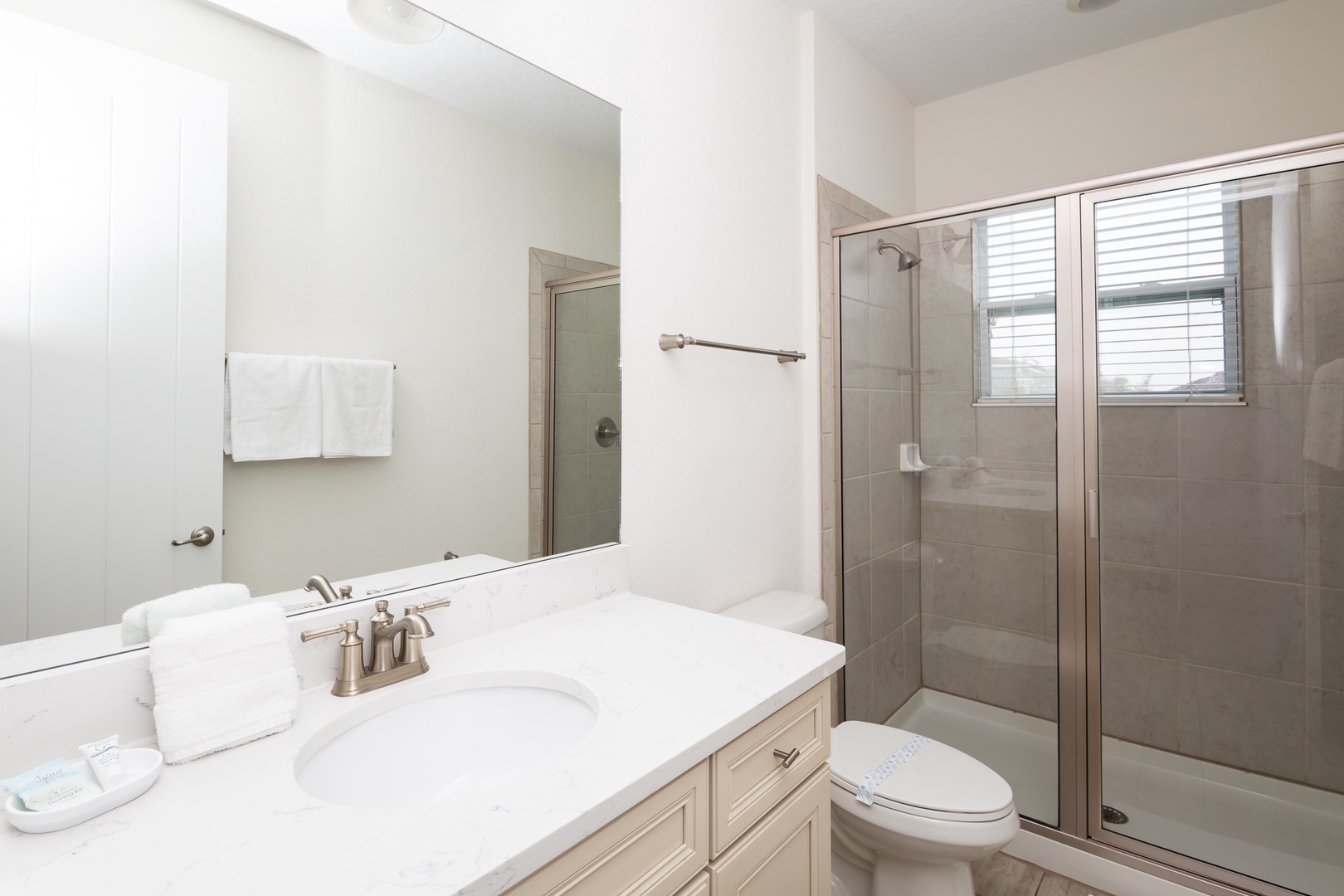A single vanity & shower await in this large ensuite bath to double twin bedroom on 2nd floor