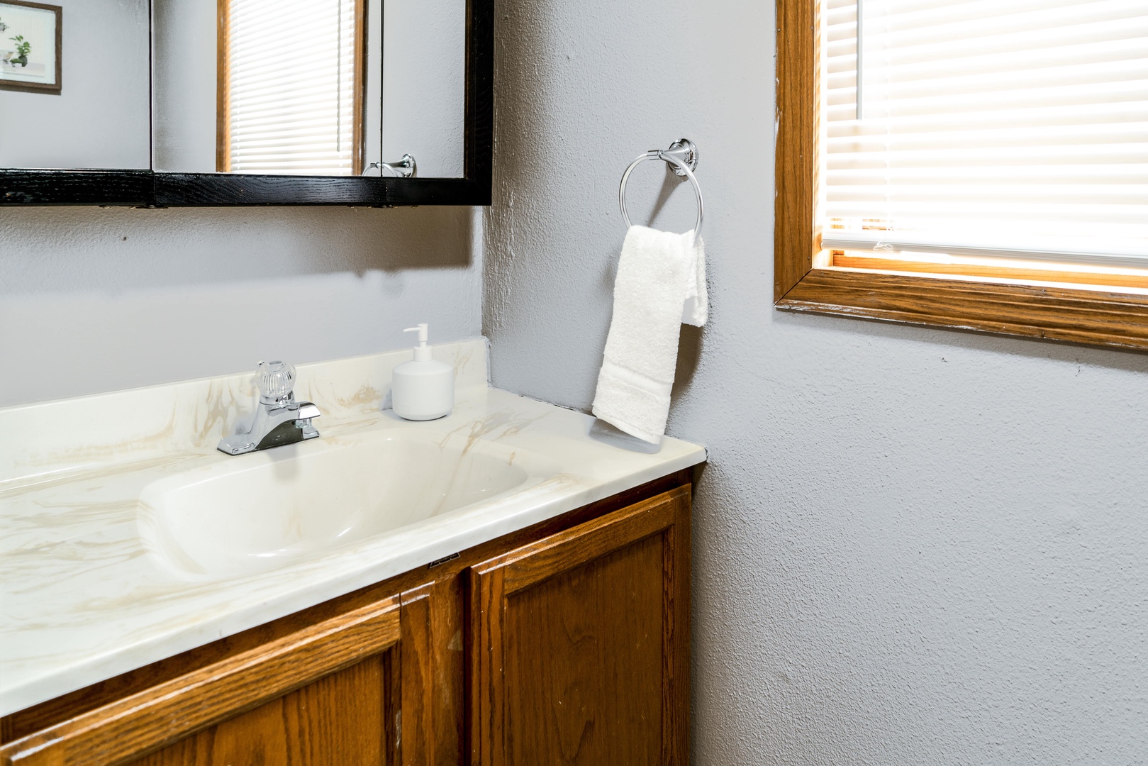 The half-shared bathroom offers a single vanity sink