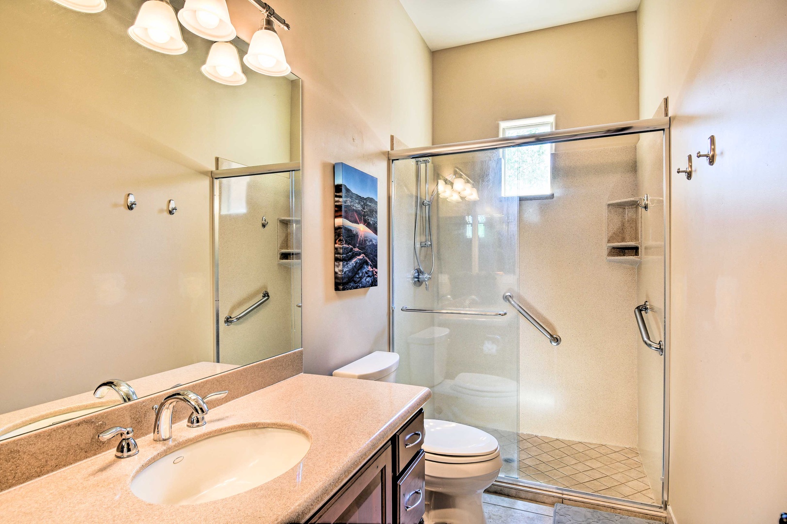 The final shared full bathroom offers a single vanity & glass shower
