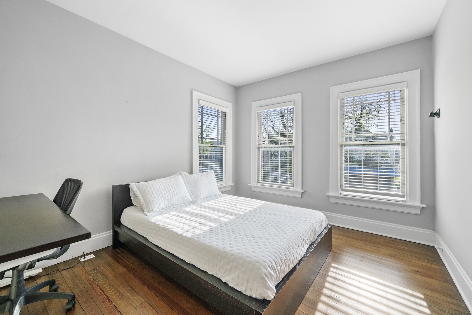 The desk workspace in this queen bedroom is ideal for catching up on emails