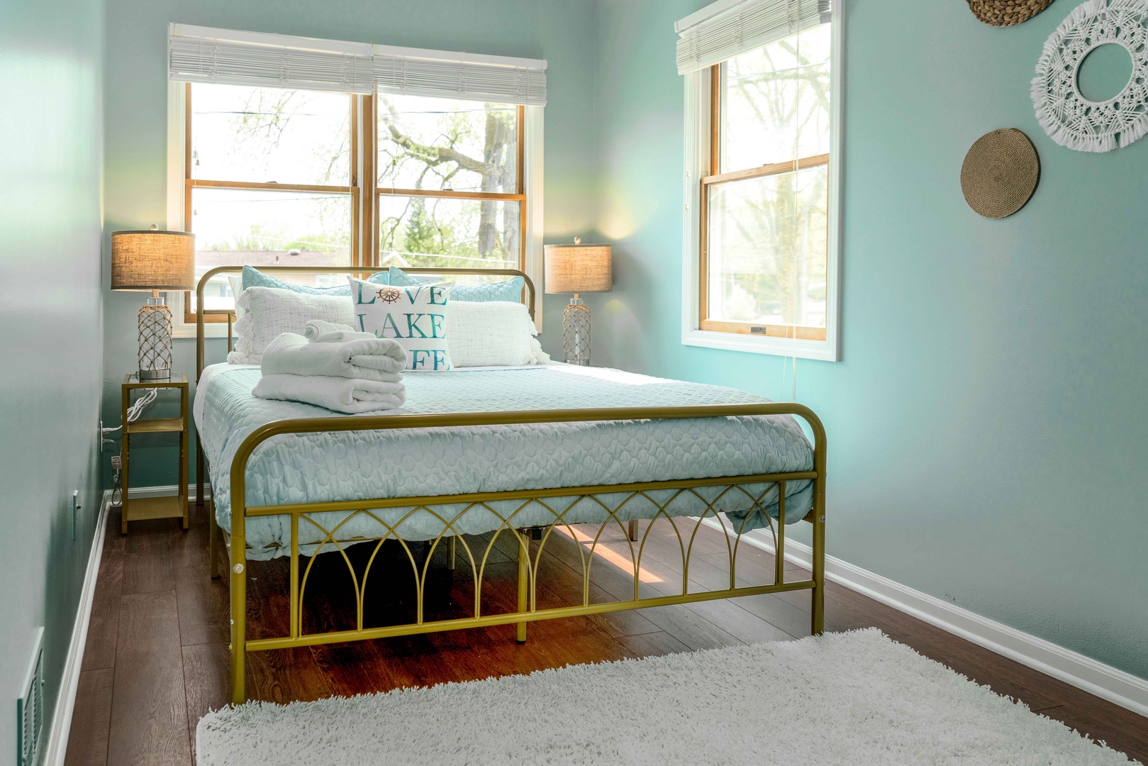 This tranquil second-floor bedroom features a queen-sized bed