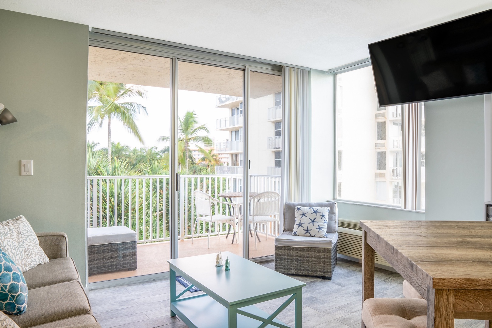 Open studio with sofa sleeper, TV, and balcony