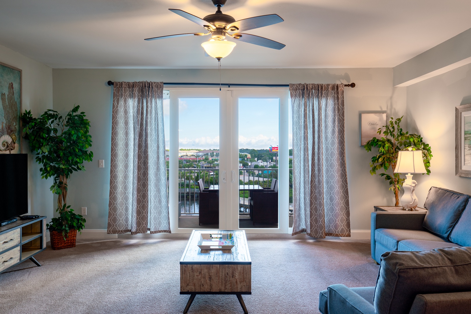 Bright open living space with sofa sleeper, TV, and breathtaking views