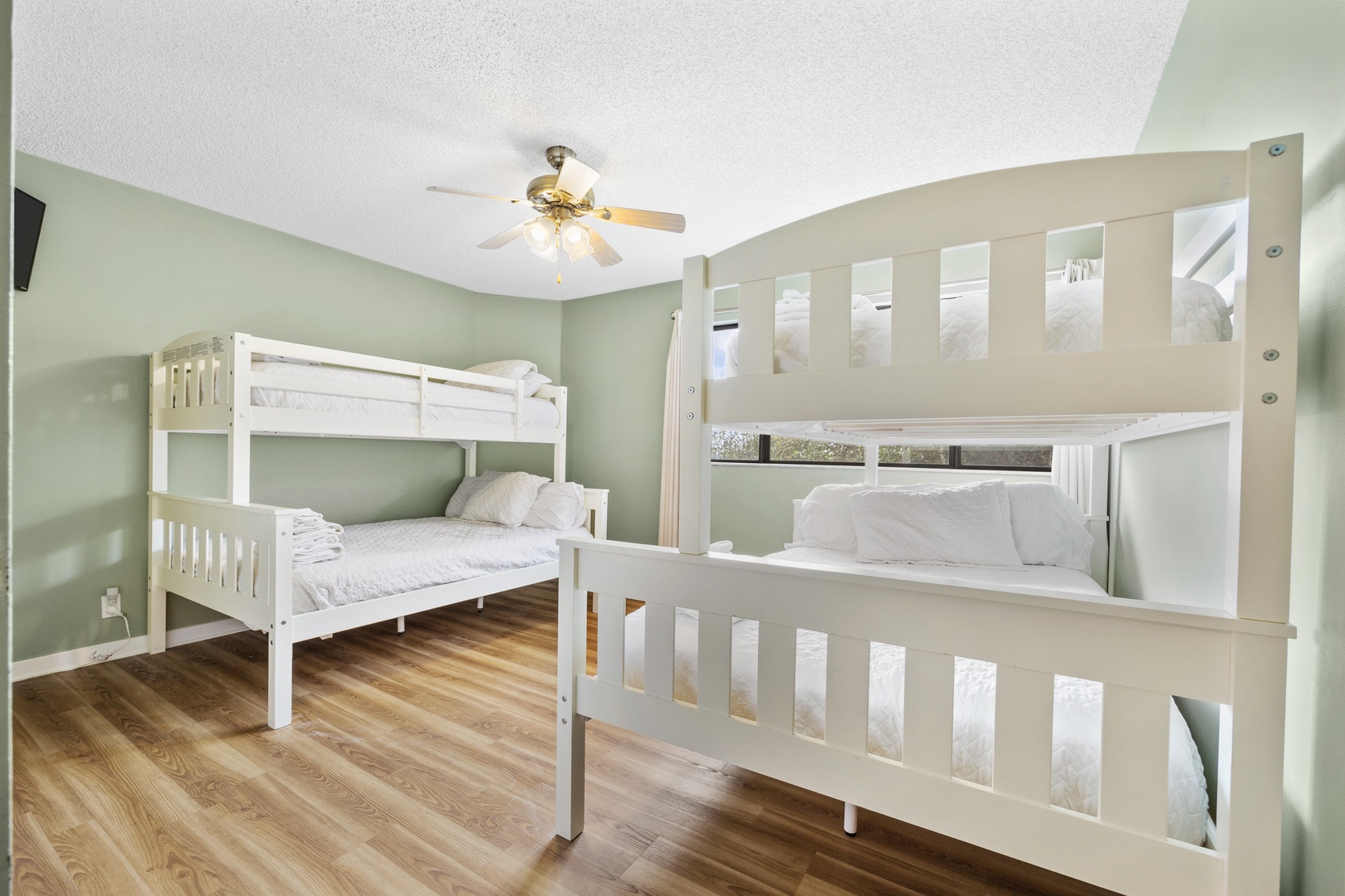 A Smart TV & pair of twin-over-full bunkbeds awaits in the third bedroom