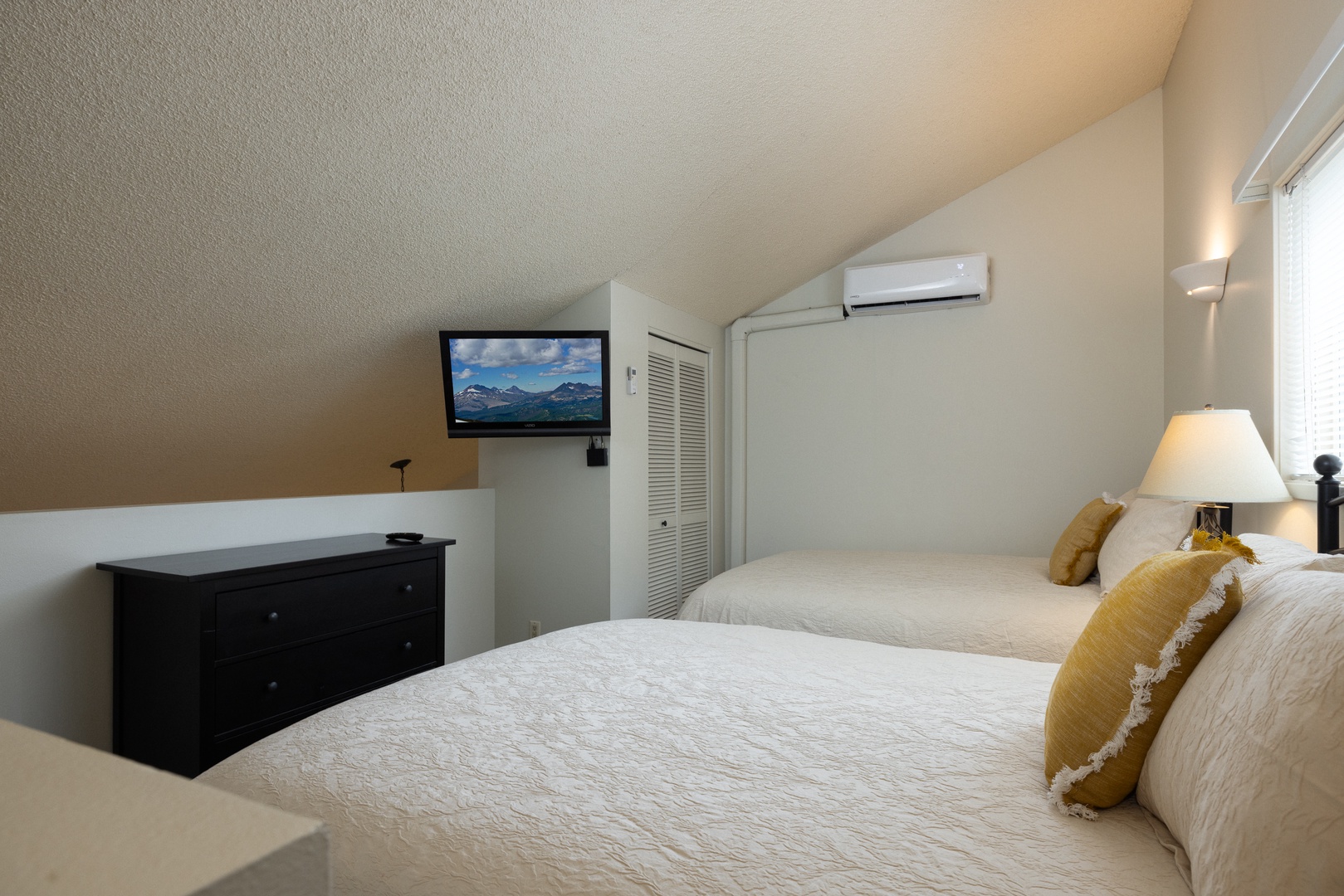 Cozy up in the loft area containing two queen beds & a Smart TV