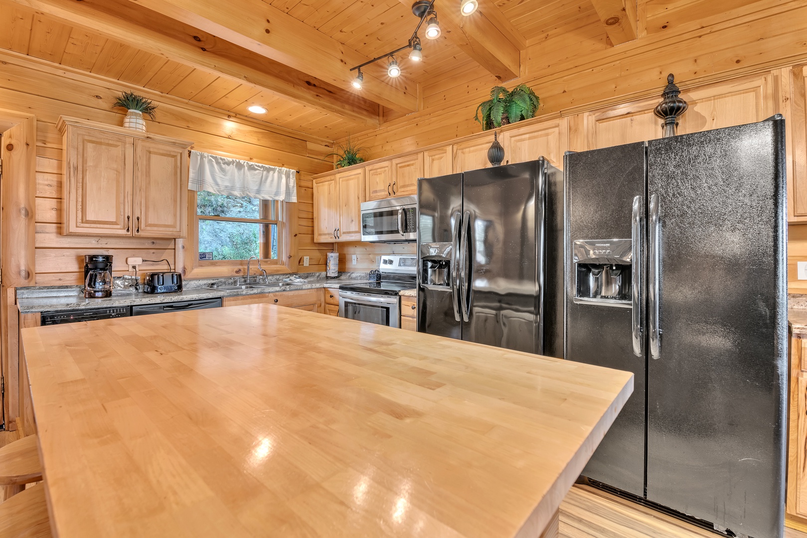 The gorgeous, rustic kitchen offers ample space & all the comforts of home