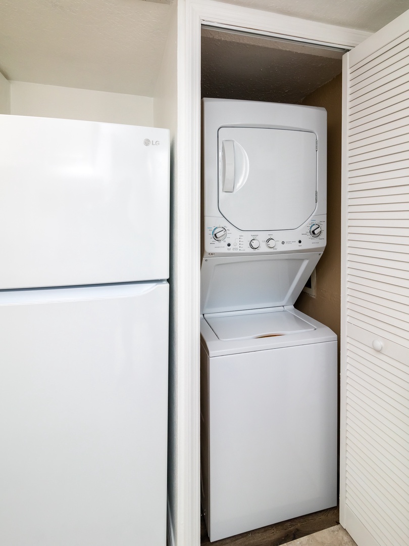 Stackable washer and dryer in the laundry closet near kitchen