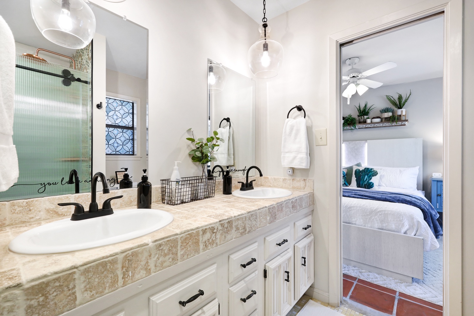 The second Jack & Jill ensuite offers dual vanities & a glass shower