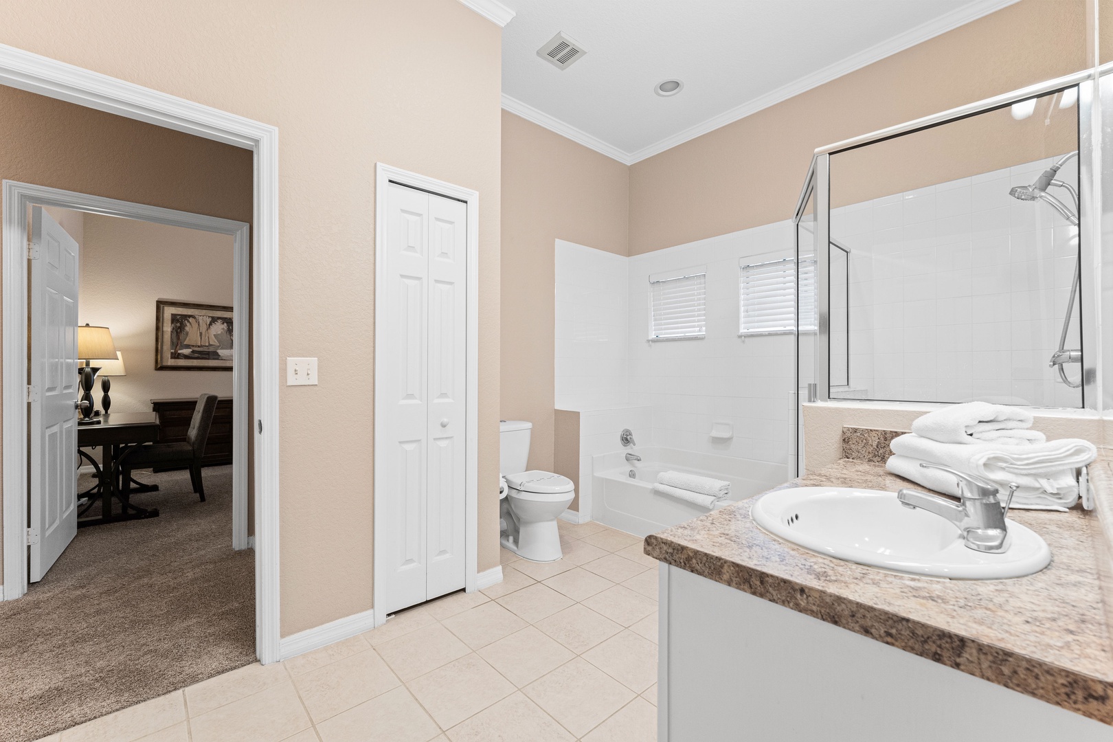 A single vanity, shower, & tub await in the Jack & Jill ensuite bath