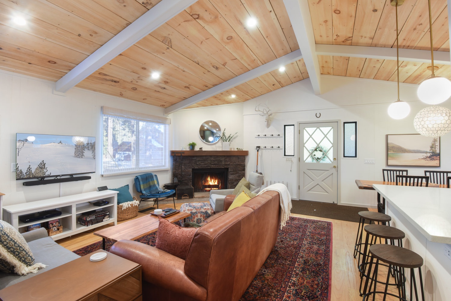 Open living space with fireplace and TV